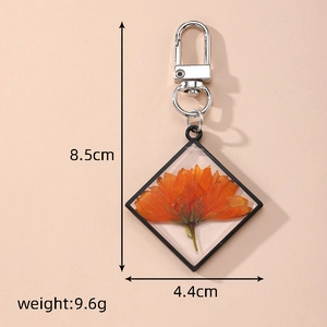 Detail view of square dried flower keychain with dimensions 8.5cm by 4.4cm and 9.6g weight