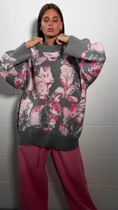 Detailed knit texture of grey sweater with pink rabbit jacquard on long sleeve