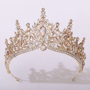 Macro shot of bridal crystal crown with teardrop rhinestones and golden leaf design