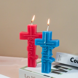 Detail of cross-shaped candles with blessed and faith embossing on white book base