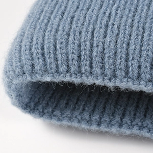 Thick knitted beanie with fuzzy texture and wide ribbed cuff in deep dusty blue color