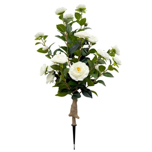 Artificial white camellia bouquet with realistic green leaves on a clean white background