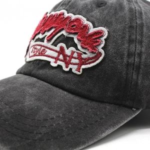 Close-up of vintage washed cotton baseball cap with detailed red and white NY embroidery