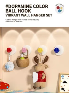 Close-up of vibrant suction cup hooks in four bright colors for damage-free wall mounting
