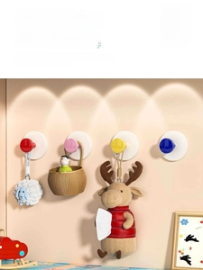 Close-up of vibrant suction cup hooks in four bright colors for damage-free wall mounting