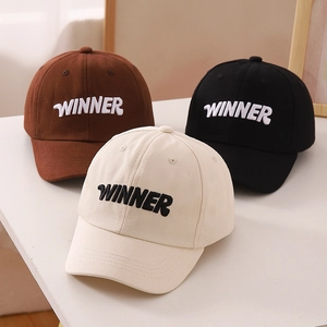Detailed embroidery of WINNER text on kids baseball caps in brown, black and beige