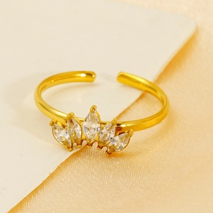 Detailed macro shot of a gold crown ring with sparkling marquise-cut zircon stones
