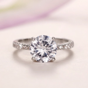 Macro close-up of the four-claw round zircon engagement ring with side stones