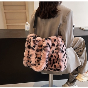 Detail of pink leopard print plush tote bag featuring soft faux fur and black strap