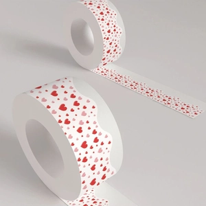 Close-up of decorative heart pattern washi tape rolls with red and pink hearts