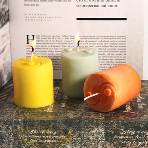 Scented pillar candles with yin yang swirl texture in yellow, green and orange tones