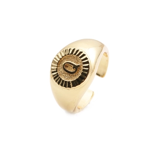 Macro shot of gold plated letter Q signet ring with adjustable open band detail