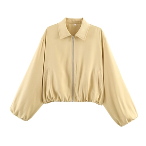 Detail of light yellow zip-up jacket collar with size S label and smooth fabric texture