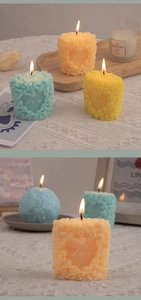 Close-up of rose embossed heart-shaped scented candles in pastel colors on a lace tablecloth