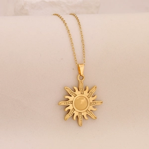 Detailed view of sun pendant necklace with gold finish and polished O-chain link