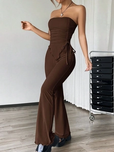 Detail of dark brown strapless tube top with drawstring and high waisted flare trousers