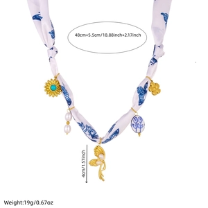Detail view of silk ribbon necklace with blue butterfly pendants and freshwater pearls