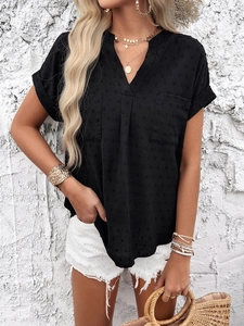 Detail of a black Swiss dot V-neck short sleeve shirt paired with white denim shorts