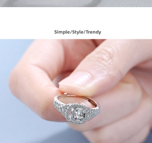 Close-up of cushion cut halo zircon ring with pavé stones on a silver-tone band