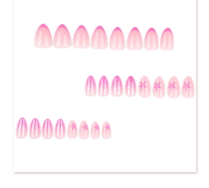 Detail of almond pink press-on nails featuring French tips, glitter, and star patterns