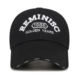 Black 1986 embroidered baseball cap with extended brim and white 3D knit lettering