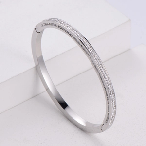 Detailed view of silver double-row crystal pave bangle on minimalist geometric cubes