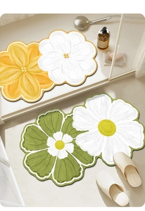 Detailed top view of absorbent floral bath mats in yellow and green oil painting style