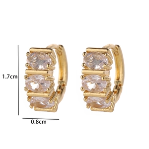Close-up of gold plated huggie earrings with oval cut zircon stones measuring 1.7cm in height