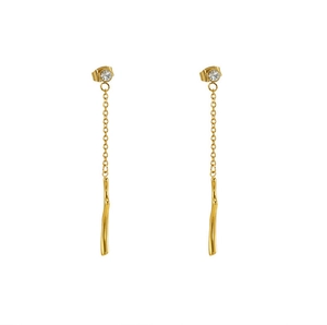 Detail of gold tassel earrings with zircon studs and hanging curved metal bars