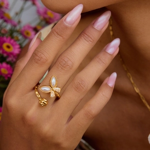 Elegant gold butterfly ring with pearl shell inlay and adjustable vine band on model