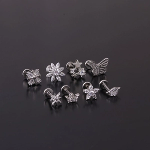 Set of 8 silver stainless steel 16G labret studs with cubic zirconia in star and flower shapes