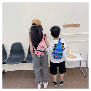 Rear view of children wearing cute school bus crossbody bags in pink and blue colors