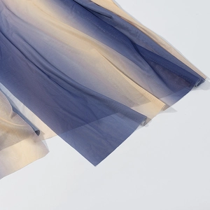Detailed macro view of gradient mesh fabric showing blue to champagne color transition