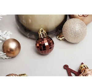 Detailed view of champagne and rose gold Christmas ornaments with various textures