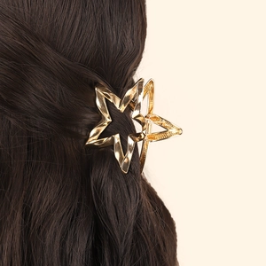 Golden hollow star hair claw clip for women's half-up hairstyle on brown hair
