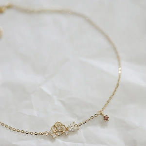Macro detail of 14K gold plated rose bracelet with purple zircon stones for women
