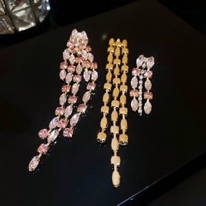 Detailed view of pink and clear marquise-cut crystal tassel earrings with gold plating