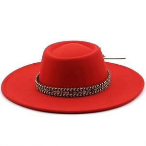 Detail of red flat top wool boater hat with ethnic woven band and brown leather cord