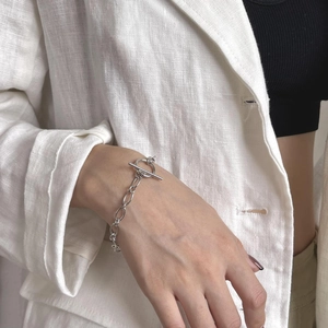 Close-up of minimalist sterling silver thick chain bracelet with a toggle clasp
