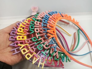 Close-up of colorful plastic Happy Birthday headbands in assorted candy colors