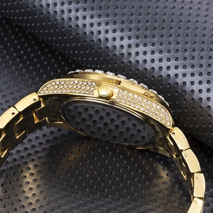 Macro side view of gold iced-out watch case with clear diamonds and metallic strap
