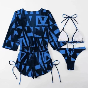 Flat lay of a 3-piece swimwear set featuring geometric print and mesh cover-up top
