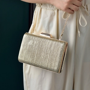 Elegant gold pleated evening clutch bag with metallic texture and sleek chain strap
