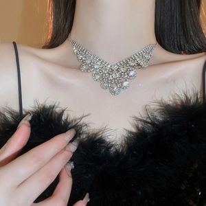 Detailed view of layered V-shaped silver choker necklace with shimmering rhinestones