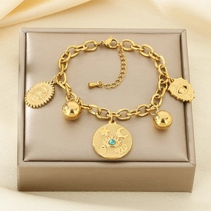 Gold stainless steel chain bracelet with evil eye and moon charms in a gift box