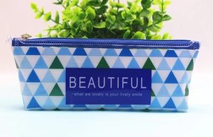 Detailed close-up of a blue and green geometric triangle pattern pencil case with zipper