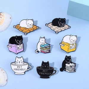 Set of eight cartoon cat enamel pins in various poses and colors on blue background