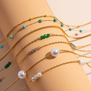 Detail of 18K gold plated stainless steel necklaces with colorful beads and pearls