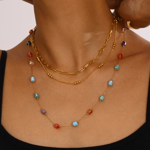 Three-layer gold necklace featuring paperclip chain, bead strand and colored beads