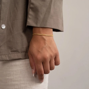 Minimalist 14k gold-plated stainless steel fine chain bracelet on woman's wrist